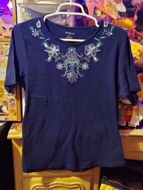 Navy short sleeve top with floral embroidery around neckline